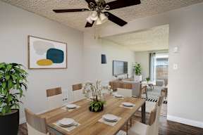 A dining room with a wooden table set for four.