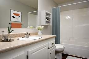 A bathroom with a white toilet and a white sink.