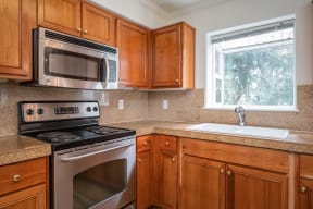 Village at Main Street | 2x2 Kitchen with Wood Cabinetry and Stainless Steel Appliances