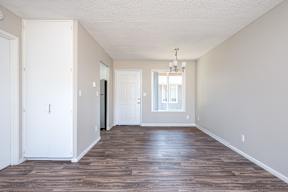 A room with wooden floors and white walls.