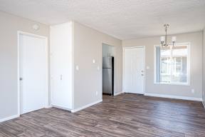 A room with a wooden floor and white walls.