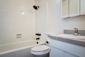 a bathroom with a sink toilet and bath tub