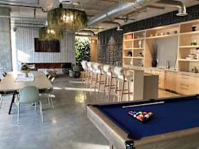 A pool table with a green cloth and a set of pool balls on it at The Anthem at Square 10 Apartments, New Haven, 06510