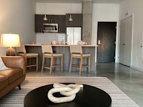 A modern living room with a black coffee table and a white sculpture on it at The Anthem at Square 10 Apartments, New Haven, CT, 06510