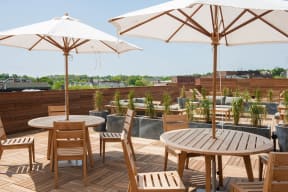 a rooftop patio with tables and chairs and umbrellas  at Iron Works Sono, Norwalk, CT