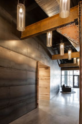 a view of the lobby with wood paneling and concrete floors  at Iron Works Sono, Norwalk, CT, 06854
