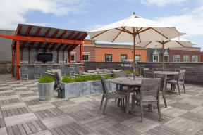 a roof deck with tables chairs and umbrellas  at Iron Works Sono, Connecticut, 06854