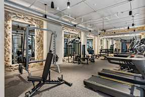 A gym with treadmills, weights, and other exercise equipment.