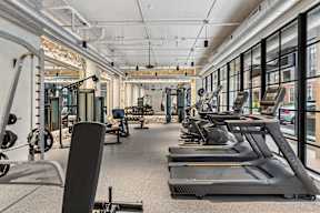 A gym with treadmills and other exercise equipment.