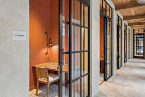A hallway with a sign that says "CO WORK" on the wall.