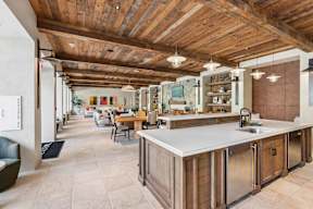 A kitchen with a wooden ceiling and a counter.