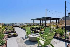 A rooftop patio with a table and chairs.