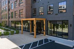 A modern building with a wooden entrance and glass windows.