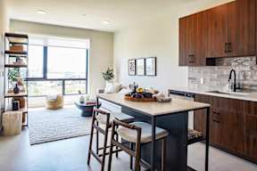 A kitchen with a table and chairs in the middle of the room.