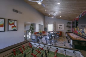 a recreation room with a foosball table and pool table