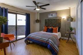 Peoria Apartments- Moxi Apartments-  a bedroom with a bed and a ceiling fan