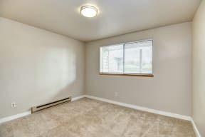 Seattle Apartments-  a bedroom with carpet and a window.