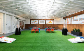 a large room with green carpet and tables and chairs