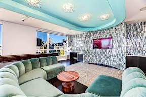 A living room with a green couch and a television.