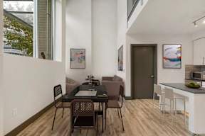 A dining table with chairs is in the middle of a room.