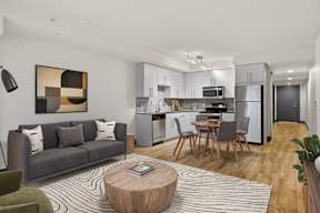A modern living room with a grey couch and a coffee table.