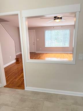 A room with a window and a ceiling fan.
