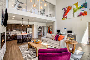 A modern living room with a purple chair and a wooden coffee table.