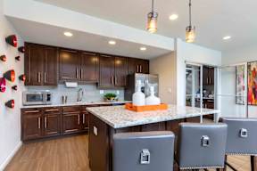 A kitchen with brown cabinets and a white countertop.