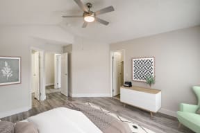 a bedroom with a bed and a ceiling fan