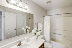 a bathroom with a large mirror and a toilet and a shower