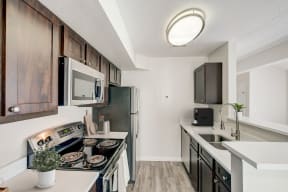 our redesigned kitchen is spacious and modern with stainless steel appliances and white countertops