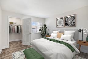 A bedroom with a white bed and a green pillow.