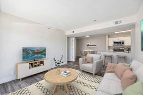 A living room with a television, couch, and coffee table.
