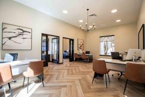 a large office with desks and chairs and a wood floor