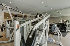 a room filled with lots of different types of exercise equipment