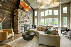 a living room with a large stone fireplace and a large couch