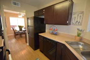 Three Bedroom Apartments in Antelope Valley CA - The Arches at Regional Center West - Modern Kitchen with Wood-Style Cabinets