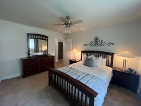 a bedroom with a large bed and a ceiling fan