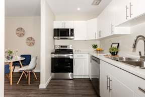 A modern kitchen with a dining table and chairs.