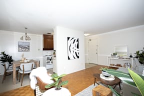 A living room with a dining table and chairs.