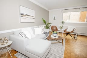 A living room with a white couch and a coffee table.