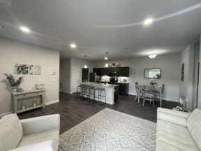 a kitchen and living room with a table and chairs