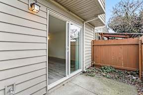 A house with a white siding and a brown fence at Stony Creek Apartments, Santa Rosa