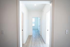 A long hallway with a door at the end.
