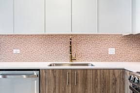 A kitchen with a sink and a dishwasher.