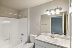 a bathroom with a mirror and a toilet and a sink