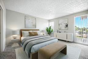 A bedroom with a large bed and a bench.