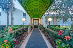 A long green covered walkway leads to a building with a sign that says "59 Leasing Office".