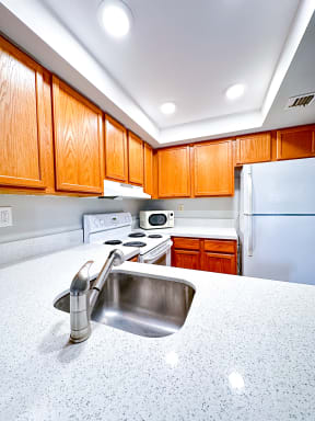 a kitchen with a sink and a refrigerator