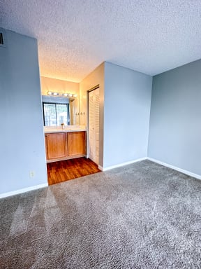 an empty room with grey walls and a bathroom
